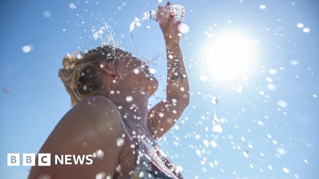 Woman pouring water on herself