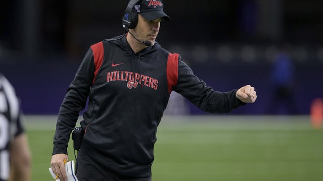 FILE - Western Kentucky head coach Tyson Helton fist bumps his players during the New Orleans Bowl NCAA football game against South Alabama in New Orleans, Dec. 21, 2022. Conference USA heads into the season in transition. In some respects, it got smaller, with six teams defecting to the American Athletic Conference. In others, it got bigger, adding large markets to show off its product. (AP Photo/Matthew Hinton, File)