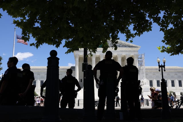 WASHINGTON, DC - JUNE 24: Capitol Police officers observe an abortion rights protest outside of the U.S. Supreme Court Building on June 24, 2024 in Washington, DC. Abortion rights and anti-abortion rights activists demonstrated outside the U.S. Supreme Court to mark two years since the court's Dobbs v. Jackson Women's Health Organization ruling, which reversed federal protections for access to abortions. (Photo by Anna Moneymaker/Getty Images)
