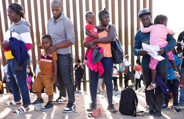 Immigrants from Haiti wait in line to be processed by the U.S. Border Patrol in Yuma, Ariz., on May 20, 2022. 