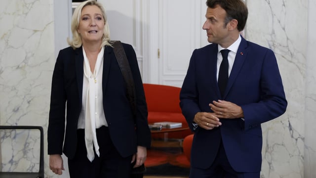 FILE - French President Emmanuel Macron, right, meets French far-right Rassemblement National (National Rally) leader Marine Le Pen at the Elysee Palace on June 21, 2022 in Paris. The perspective of a defeat in parliamentary elections mean he may have to share power with a prime minister from rival political party — that could possibly be far-right National Rally's president Jordan Bardella. Macron defeated twice the National Rally's leader Marine Le Pen in the presidential election, both in 2017 and 2022. (Ludovic Marin/Pool photo via AP, File)