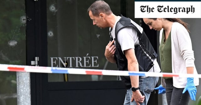 Police officers are at work on the site of a shooting that occured overnight during a wedding party in Thionville, eastern France