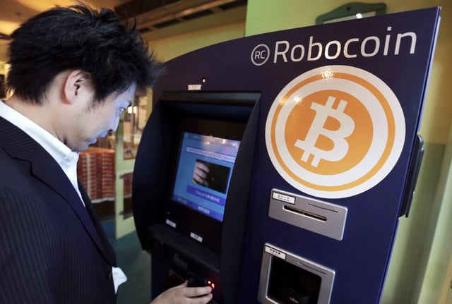 A customer purchases bitcoins from a bitcoin ATM, in Tokyo, Japan, on June 18, 2014. 