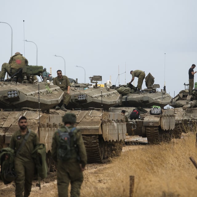 Israeli soldiers organize their armored personnel carriers as they move in formation near the Israeli border with Lebanon on October 15, 2023, near Amiad, Israel. Civil authorities and military units in northern Israel are now steeling themselves for a full-scale war with Lebanese-based militant group, Hezbollah, after months of rockets, drones and missiles being exchanged across the border.