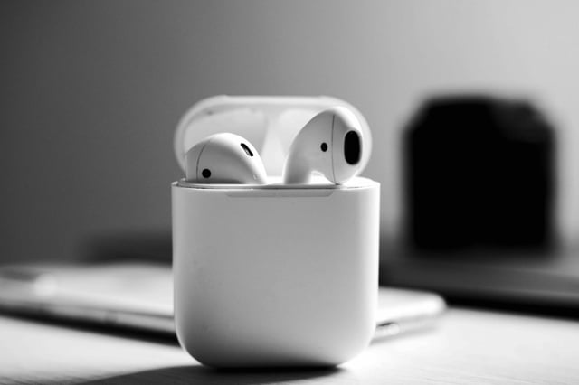 White AirPods in a charging case.