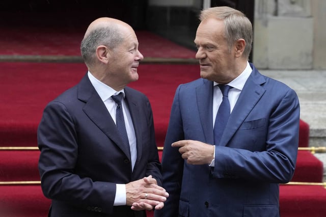 German Chancellor Olaf Scholz, left, and Polish Prime Minister Donald Tusk review the guard of honor before German-Polish inter-governmental consultations in front of Prime Minister Chancellery in Warsaw, Poland, Tuesday, July 2, 2024.