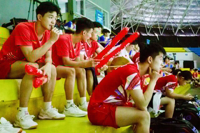 Chinese badminton players watch their teammates from the stands during the 2024 Asia Junior Championship in Yogyakarta, on July 1, 2024. 