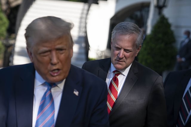 Mark Meadows, White House chief of staff, listens as U.S. President Donald Trump, left, speaks to members of the media on Wednesday, July 29, 2020.