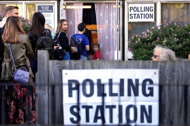 People queue at a polling station in London, Thursday, July 4, 2024. Voters in the U.K. are casting their ballots in a national election to choose the 650 lawmakers who will sit in Parliament for the next five years. Outgoing Prime Minister Rishi Sunak surprised his own party on May 22 when he called the election. (AP Photo/Vadim Ghirda) - Image ID: 2XFJF60