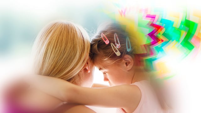 A photo of a blonde woman holding a young child. Colorful zigzags are shown around the child's head, indicating that she's experiencing a migraine with aura