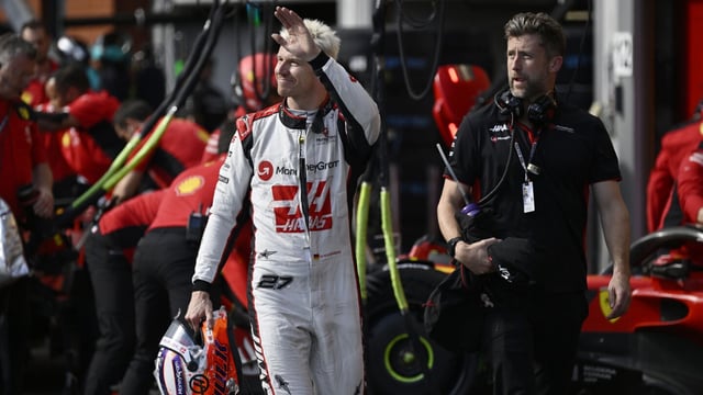 Haas driver Nico Hulkenberg of Germany waves as he walks near his team garage during the qualifying session ahead of the Formula One Grand Prix at the Spa-Francorchamps racetrack in Spa, Belgium, Friday, July 28, 2023. The Belgian Formula One Grand Prix will take place on Sunday. (John Thys, Pool Photo via AP)