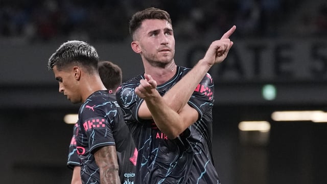 Manchester City's Aymeric Laporte, center, celebrates with teammates after scoring a goal against Bayern during a friendly soccer match at the National Stadium in Tokyo, Japan, Wednesday, July 26, 2023.(AP Photo/Shuji Kajiyama)