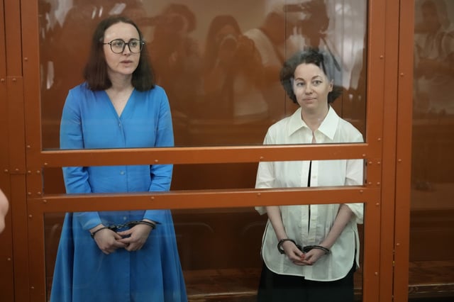 Theater director Zhenya Berkovich, right, and playwright Svetlana Petriychuk are seen in a glass cage prior to a hearing in a court in Moscow, Russia, Monday, July 8, 2024. Berkovich, a prominent independent theater director, and Petriychuk, a playwright have been behind bars since early May. Authorities claim a play they staged, "Finist, the Brave Falcon," justifies terrorism, which is a criminal offence in Russia punishable by up to seven years in prison. (AP Photo/Alexander Zemlianichenko)