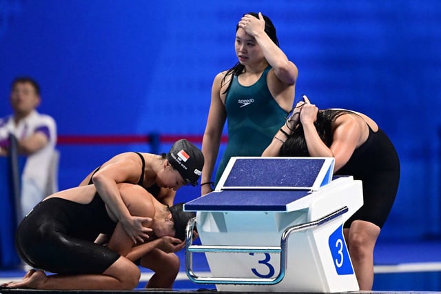 Members of Singapore’s team react after being disqualified in the final of the 4x100m medley relay at the Asian Games in Hangzhou. Photo: AFP