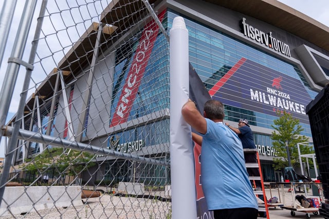Signage is attached to security fencing ahead of the 2024 Republican National Convention at the Fiserv Forum, Wednesday, July 10, 2024, in Milwaukee. (AP Photo/Alex Brandon)