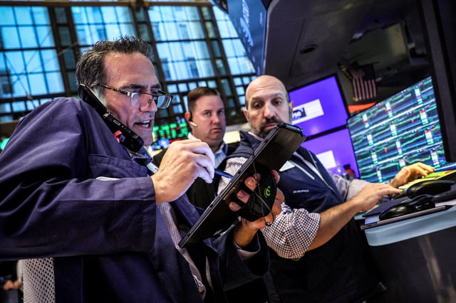 Traders work on the floor at the New York Stock Exchange (NYSE) in New York on July 3, 2024. 