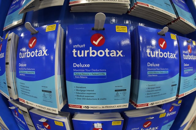 Intuit TurboTax packages are seen on display in a Costco Warehouse, Jan. 26, 2023, in Pittsburgh. Tax preparation and financial software company Intuit announced an AI-focused reorganization plan Wednesday, July 10, 2024, that includes laying off about 10% of its workforce. (AP Photo/Gene J. Puskar, File)