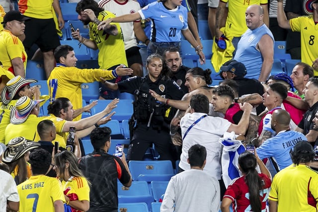 CHARLOTTE, NC - JULY 10: Uruguay forward Darwin Núñez (19) engages with hostile fans in the stands after the CONMEBOL Copa America semifinal between Uruguay and Colombia on Wednesday July 10, 2024 at Bank of America Stadium in Charlotte, NC. (Photo by Nick Tre. Smith/Icon Sportswire) (Icon Sportswire via AP Images)