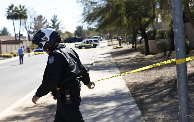Phoenix Police Department officer, puts up tape