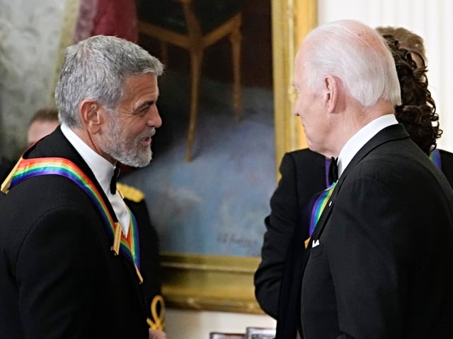 FILE - President Joe Biden shakes hands with actor, director and producer George Clooney during the Kennedy Center honorees reception at the White House in Washington, Dec. 4, 2022. Movie star and lifelong Democrat George Clooney is adding his voice to calls for Joe Biden to leave the presidential race. Clooney says in a New York Times opinion piece Wednesday that he loves Biden, but the party would lose the presidential race as well as any control in Congress with him as the nominee. (AP Photo/Manuel Balce Ceneta)