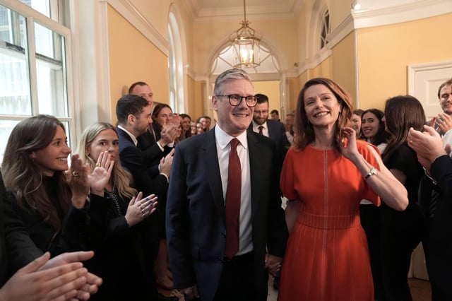 Britain's newly elected Prime Minister Keir Starmer and his wife Victoria enter his official London residence at No 10 Downing Street for the first time after the Labour Party won a landslide victory in the 2024 general election, in London, Friday July 5, 2024. (Stefan Rousseau/Pool Photo via AP)
