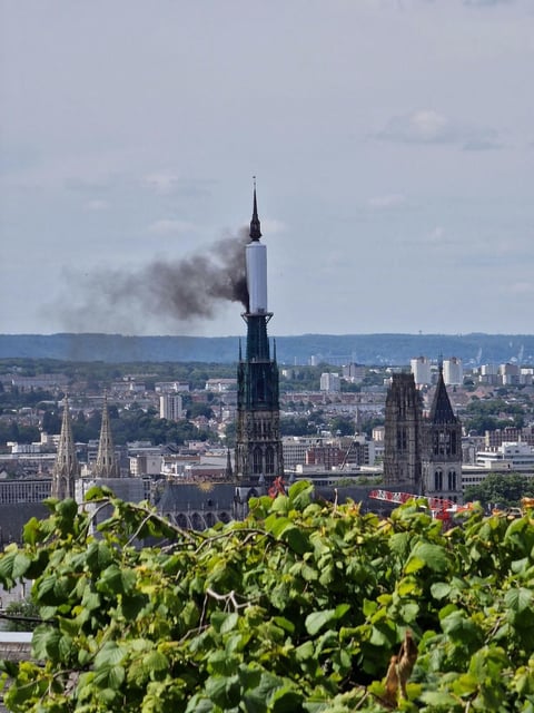 Smoke billows from the spire of Rouen Cathedral in Rouen, northern France on Thursday.