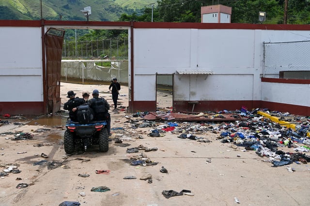 Members of the Bolivarian National Police patrol on a quad bike at the Tocoron prison in Tocoron, Aragua State, Venezuela, on September 23, 2023. The bosses of the Tren de Aragua gang used Tocoron prison as a base for their international crime operations.