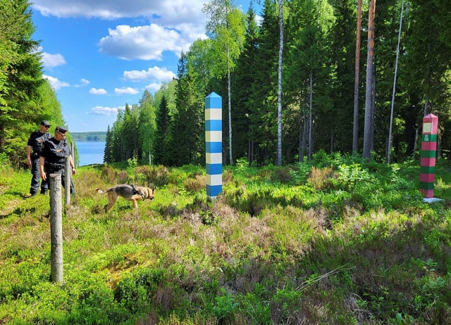 FILE PHOTO: Finnish border guards and their dog Nita patrol the Finnish-Russian border which is marked by a narrow clearing in the forest near Hoilola village, in Eastern Finland, June 5, 2024. REUTERS/Anne Kauranen/File Photo