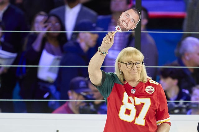 PHOENIX, AZ - FEBRUARY 06: Donna Kelce holds up a photo of her son Travis Kelce #87 of the Kansas City Chiefs at Footprint Center on February 6, 2023 in Phoenix, Arizona. (Photo by Cooper Neill/Getty Images)