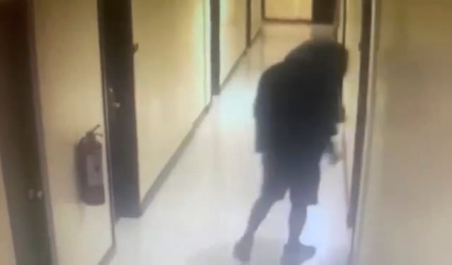 A man, who police identified as the suspect, walks along a hallway before entering a room at the Lake Hotel in Tagaytay in this still from surveillance footage. Photo: Cavite Provincial Police Office via AP
