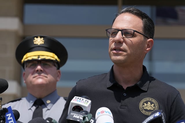 Josh Shapiro, right, governor of Pennsylvania, speaks during a news conference, in Butler, Pa., on Sunday, July 14, 2024, concerning the apparent assassination attempt of former President Donald Trump.