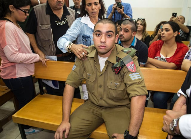 Israeli soldier Elor Azaria, who was caught on video shooting a wounded Palestinian assailant in the head as he lay on the ground, sits during a hearing at a military appeals court in Tel Aviv during which he was charged with manslaughter on April 18, 2016.
Prosecutors presented the indictment to a military court over the March 24 killing, which occurred minutes after the Palestinian had stabbed another soldier and lay prone on the ground wounded by gunfire, according to Israeli authorities. He was also charged with conduct unbecoming of his rank and position in the army.
 / AFP / JACK GUEZ        (Photo credit should read JACK GUEZ/AFP/Getty Images)