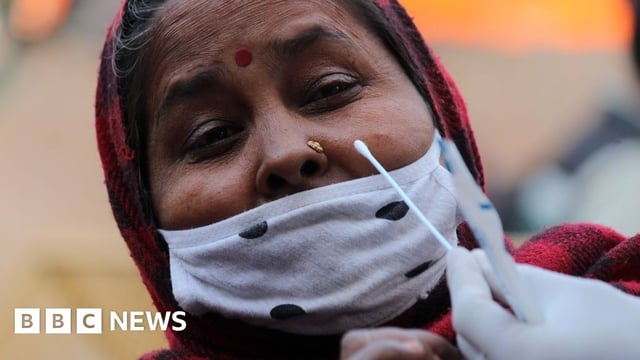A woman in India receiving a Covid test