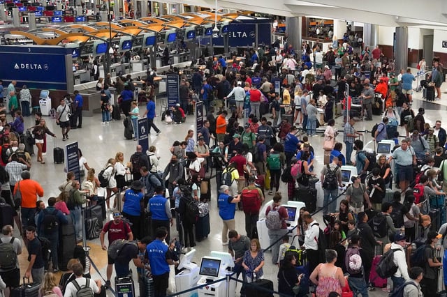 People wait in line at Hartsfield-Jackson International Airport on July 20, 2024 in Atlanta, Georgia.
