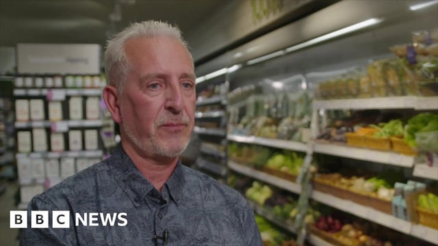 Richard Fowler in front of a fridge of fresh produce