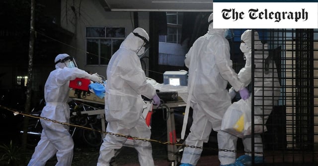 A patient is moved to an ICU on a specialist Nipah ward in the southern state of Kerala last week