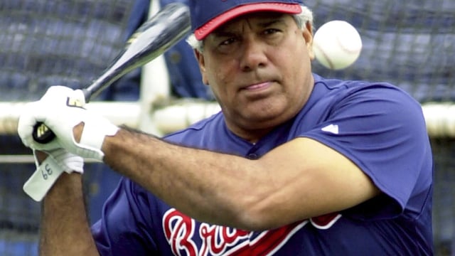 FILE - Atlanta Braves coach Pat Corrales hits ground balls during batting practice Oct. 11, 2001, at Turner Field in Atlanta. Corrales, who managed the Texas Rangers, Cleveland Indians and Philadelphia Phillies before a long stint on the Braves coaching staff under Hall of Fame skipper Bobby Cox, has died at age of 82. (AP Photo/Ric Feld, File)