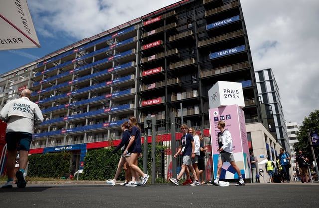Paris, France; July 23, 2024; Athletes walk past the Team USA accommodation block in the Olympic village ahead of the Paris 2024 Olympics.