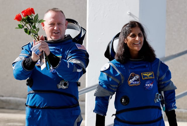 NASA astronauts Butch Wilmore and Suni Williams walk at NASA's Kennedy Space Center, on the day of Boeing's Starliner-1 Crew Flight Test mission to the International Space Station, in Cape Canaveral, Florida, U.S., June 1, 2024.