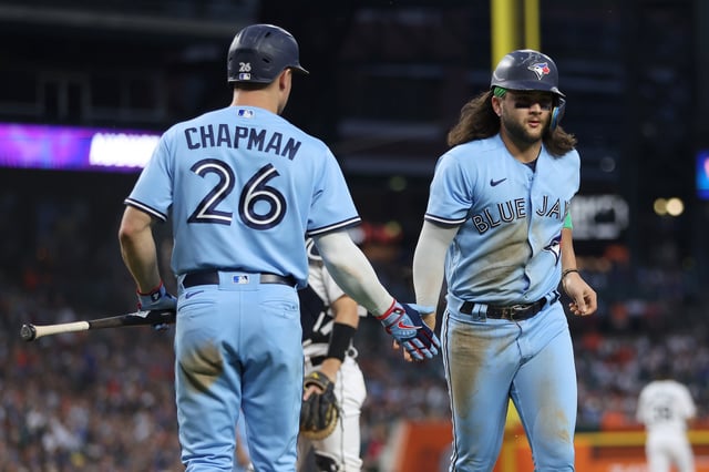 DETROIT, MICHIGAN - JULY 07: Bo Bichette #11 of the Toronto Blue Jays celebrates scoring a run in the ninth inning with Matt Chapman #26 while playing the Detroit Tigers at Comerica Park on July 07, 2023 in Detroit, Michigan.