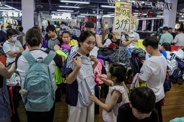 Customers at a discount clothing shop in Beijing. Consumer confidence in China remained depressed in the first half of the year. Photo: Reuters