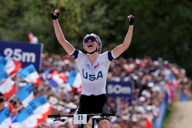 Santa Cruz’s Haley Batten of the United States celebrates her second-place finish during the women’s cross-country cycling mountain bike final at Elancourt, France, on Sunday.