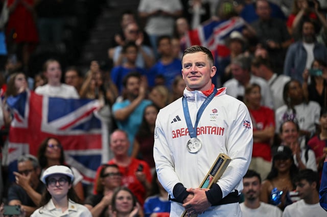 Silver medallist Britain's Adam Peaty stands on the podium of the men's 100m breaststroke swimming event during the Paris 2024 Olympic Games at the Paris La Defense Arena in Nanterre, west of Paris, on July 28, 2024. 