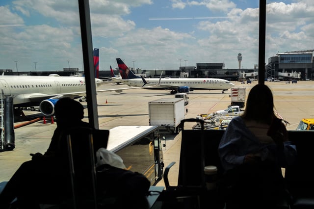 Passengers wait before boarding as an Airbus A321 passenger aircraft of Delta Airlines moves along the tarmac at Hartsfield-Jackson Atlanta International Airport in Atlanta, Georgia on June 21, 2024. (Photo by Charly TRIBALLEAU / AFP)