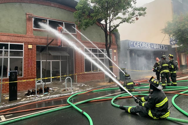 Firefighters respond to a fire at East Bay Booksellers in Oakland, Calif., July 30, 2024.