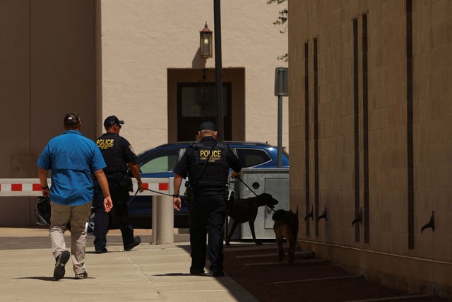 Police officers with K-9 dogs walk outside the federal court where alleged Mexican drug kingpin Ismael "El Mayo" Zambada was due appear in court on August 1, 2024.