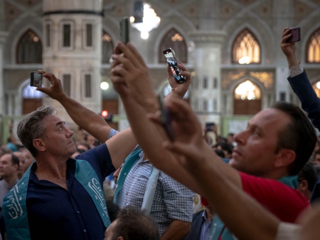 Supporters of Iranian President-elect Masoud Pezeshkian are taking photographs with their cellphones while participating in a ceremony with Pezeshkian's presence at the Khomeini shrine in southern Tehran, Iran, on July 6, 2024. Former reformist Member of Parliament, Masoud Pezeshkian, is being elected as the new President of Iran. (Photo by Morteza Nikoubazl/NurPhoto via Getty Images)