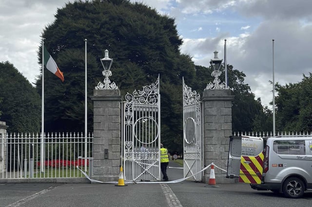The gates at Dublin's Phoenix Park, the official residence of Ireland's President, Michael D Higgins, where Irish police are investigating an incident of criminal damage, Friday Aug. 2, 2024. Irish police say a driver has been arrested in Dublin after crashing his van into gates outside the offices of the prime minister and several other government buildings. (Cate McCurry/PA via AP)