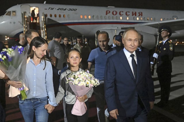 President Vladimir Putin meets convicted Russian spies released as part of a prisoners' swap at Vnukovo International Airport in Moscow.