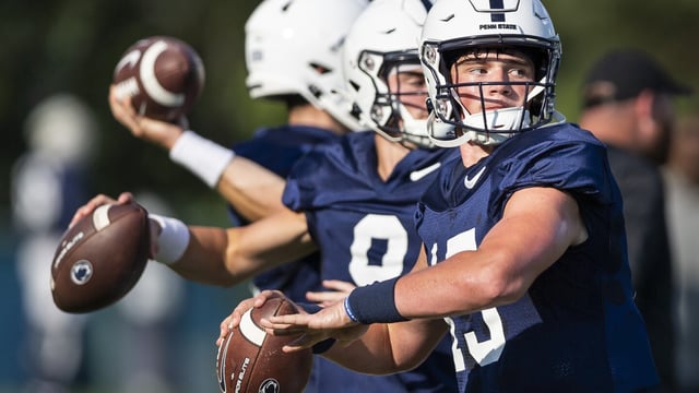 FILE - Penn State quarterback Drew Allar, front right, throws downfield during an NCAA college football practice in State College, Pa., Monday, Aug. 29, 2022. Allar might be the most important player in college football this season.(Joe Hermitt/The Patriot-News via AP, File)
